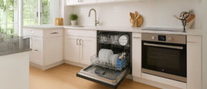 Modern kitchen with an open dishwasher filled with sparkling clean dishes, illustrating What is a Dishwasher and how it simplifies kitchen cleanup.