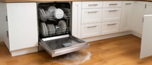 Open dishwasher with water overflowing onto the floor, showcasing a common issue of a non-draining dishwasher
