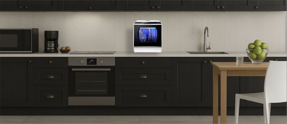 A kitchen image with AIRMSEN AE-TDQR03 dishwasher on the top of the kitchen counter, which is 3'0" from the floor. A man of 5'10" height and a woman of 5'5" height are present in the kitchen.