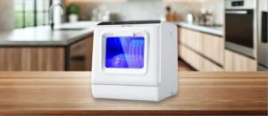 In this Ecozy ‎DW CT200A Dishwasher Review image, the countertop (compact / benchtop) dishwasher is displayed on a counter in a kitchen, showcasing its stylish appearance and practical placement for everyday use.