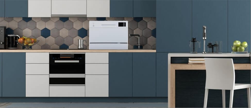 A kitchen image with SPT SD-2225DSA dishwasher on the top of the kitchen counter, which is 3'0" from the floor. A man of 5'10" height and a woman of 5'5" height are present in the kitchen.