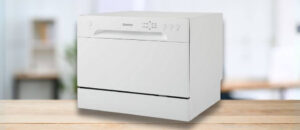 Danby DDW621WDB Dishwasher Review image showing the countertop (tabletop / benchtop) dishwasher set up on a kitchen counter, drawing attention to its minimal footprint and user-friendly front panel.