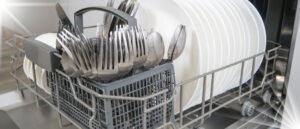 A full load of clean dishes and utensils in dishwasher racks, highlighting the organization and capacity of modern dishwasher racks.