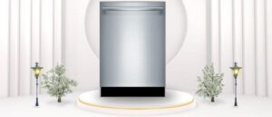 A featured image of the topic BOSCH SHX78B75UC Dishwasher Review. A BOSCH SHX78B75UC (24"inches) dishwasher is showcased on a pedestal with a glowing halo at the base, flanked by ornamental plants and other things, set against a backdrop of elegant white curtains.