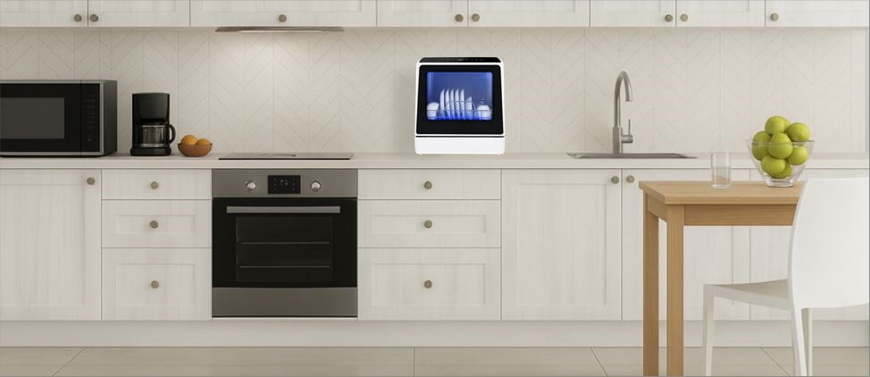 A kitchen image with KAPAS KPS-XWJ01 dishwasher on the top of the kitchen counter, which is 3'0" from the floor. A man of 5'10" height and a woman of 5'5" height are present in the kitchen.