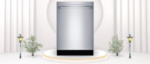 A featured image of the topic BOSCH SHXM88Z75N Dishwasher Review. A BOSCH SHXM88Z75N dishwasher is showcased on a pedestal with a glowing halo at the base, flanked by ornamental plants and other things, set against a backdrop of elegant white curtains.