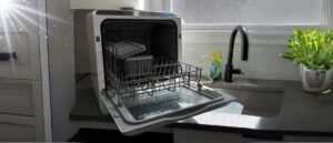 Compact open dishwasher on kitchen counter illustrating one of the 8 Best Countertop Dishwashers For Small Kitchens.