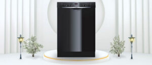 A featured image of the topic BOSCH SHE3AR76UC Dishwasher Review. A BOSCH Black SHE3AR76UC dishwasher is showcased on a pedestal with a glowing halo at the base, flanked by ornamental plants and other things, set against a backdrop of elegant white curtains.