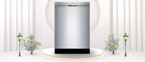 A featured image of the topic BOSCH SHSM63W55N Dishwasher Review. A BOSCH SHSM63W55N dishwasher is showcased on a pedestal with a glowing halo at the base, flanked by ornamental plants and other things, set against a backdrop of elegant white curtains.