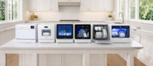 Bright and modern kitchen interior with large windows, showcasing Six Best Featured Countertop Dishwashers neatly arranged on the counter, including sleek white and glass-front designs, all organized in a clean and visually appealing display that highlights premium style and functionality.