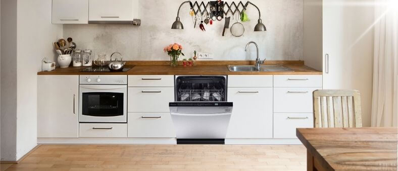 A modern kitchen with a minimalist design featuring a Kalamera ‎KWM2414H dishwasher integrated into wooden cabinetry with a countertop alongside other kitchen appliances and utensils.
