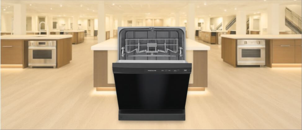 17_Frigidaire-FFCD2413UB-dishwasher-review In this Frigidaire FFCD2413UB Dishwasher Review image, the built-in (under-counter) dishwasher is displayed in a showroom setting, highlighting its modern design and front panel.