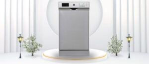 A featured image of the topic RCA RZ0381 Dishwasher Review. A RCA RZ0381 dishwasher is showcased on a pedestal with a glowing halo at the base, flanked by ornamental plants and other things, set against a backdrop of elegant white curtains.