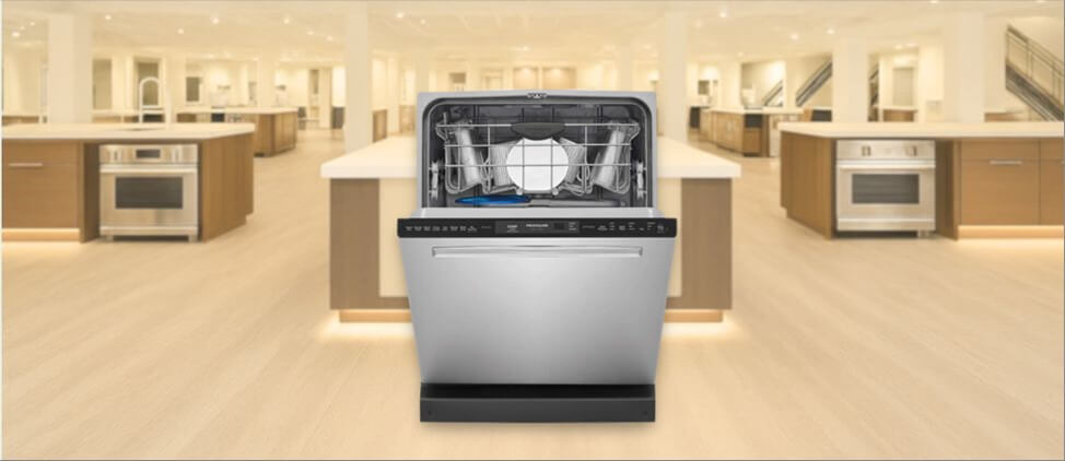 Frigidaire FGIP2468UF Dishwasher  image showing the built-in (under-counter) dishwasher is placed in a showroom, emphasizing its streamlined front panel and modern aesthetic.