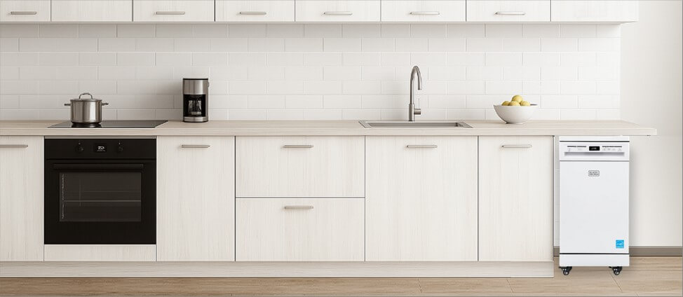 A sleek, modern kitchen featuring minimalistic cabinetry and polished surfaces. Positioned neatly in the corner, the freestanding BLACK+DECKER BPD8Wdishwasher blends convenience with flexibility, showing how well it fits into a functional yet dynamic kitchen space.