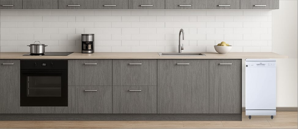 A bright, contemporary kitchen with built-in cabinetry and modern appliances. In the corner, the freestanding Danby DDW1805EWP dishwasher stands independently on its wheels, offering both mobility and functionality without disrupting the clean, open kitchen layout.