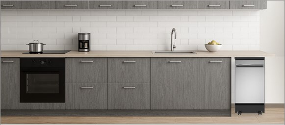 A bright, contemporary kitchen with built-in cabinetry and modern appliances. In the corner, the freestanding GE GPT145SSLSS dishwasher stands independently on its wheels, offering both mobility and functionality without disrupting the clean, open kitchen layout.