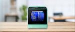 AIRMSEN C01 Dishwasher Review – A sleek AIRMSEN C01 countertop dishwasher with a transparent viewing window, placed on a wooden counter in a modern kitchen setting. The digital display is visible.
