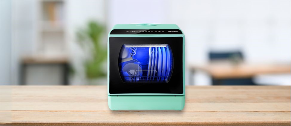 Feature image of AIRMSEN C01 Dishwasher Review: The image features a countertop (mini / compact) dishwasher placed on a kitchen counter, highlighting its sleek design and modern finish that fits well in small kitchens or apartments.