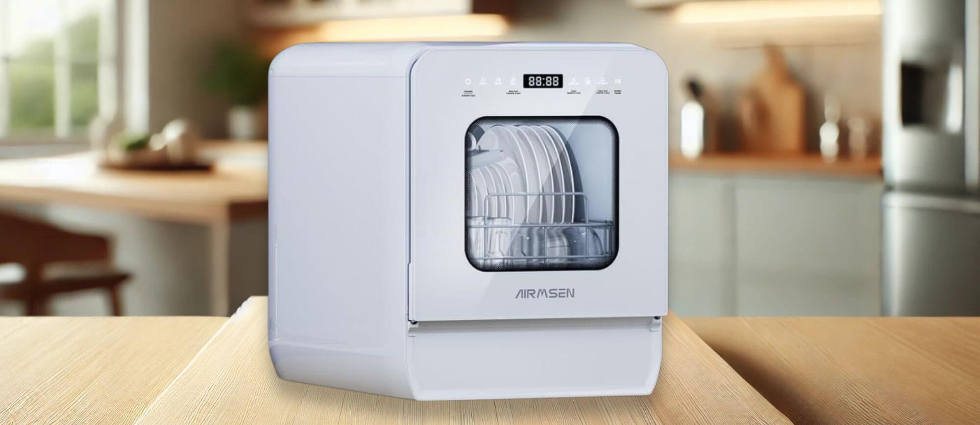 AIRMSEN C01 Dishwasher Review – A sleek AIRMSEN C01 countertop dishwasher with a transparent viewing window, placed on a wooden counter in a modern kitchen setting. The digital display is visible.