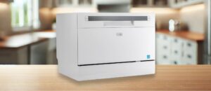 BLACK+DECKER BCD6SD Dishwasher in a Kitchen Setting: The BLACK+DECKER BCD6SD countertop dishwasher placed on a wooden counter in a modern kitchen; features a white body with a glossy black control panel. It is a featured image of a topic "BLACK + DECKER BCD6SD dishwasher review"