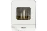 Hermitlux HDW5CW02 Dishwasher - Front View: A compact countertop dishwasher with a transparent viewing window, displaying stacked plates inside, showcasing its three-place setting capacity.