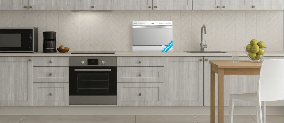 A size comparison graphic illustrating the Midea MDC22P2ASS dishwasher's dimensions in relation to a kitchen counter and standard human heights. The diagram provides a visual reference for users to gauge its compact form factor and placement in a typical kitchen setup.