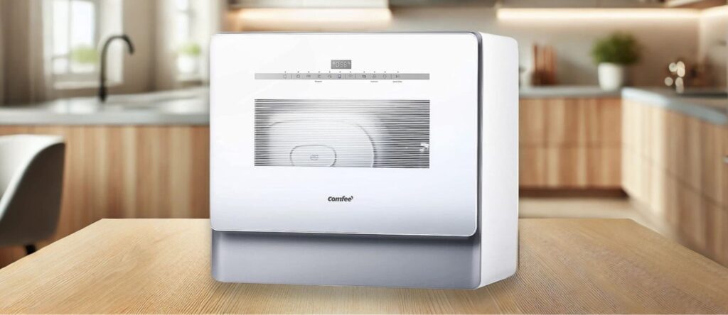COMFEE CDC22P4AWW Dishwasher Review – Compact countertop dishwasher on a wooden kitchen table with a modern kitchen background.