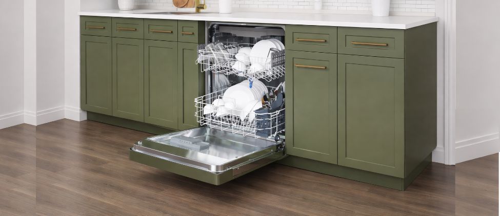 Modern built-in dishwasher installed in a stylish green kitchen cabinet, door open showing loaded racks and clean dishes for KoolMore KM-DW2445-PR dishwasher review.
