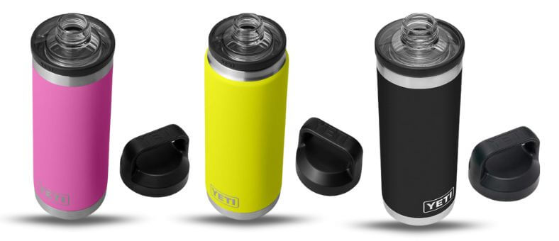 Three YETI Rambler bottles in pink, yellow, and black with open chug caps placed beside them.
