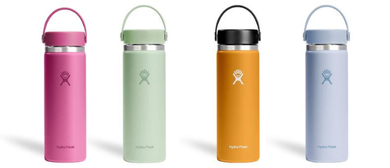 Four Hydro Flask water bottles in pink, mint green, orange, and lavender colors with flexible carrying handles.