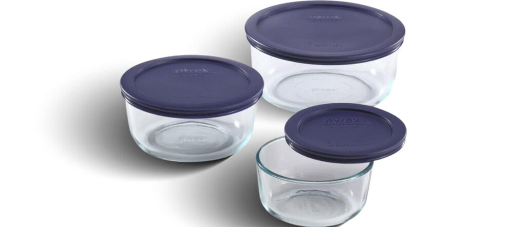 A 3-piece set of round Pyrex Simply Store glass food storage bowls with navy blue lids on a white background.