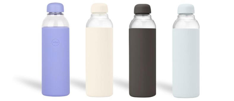 W&P Porter Glass Water Bottles in soft pastel colors with silicone sleeves and twist-off lids, dishwasher safe and stylish.