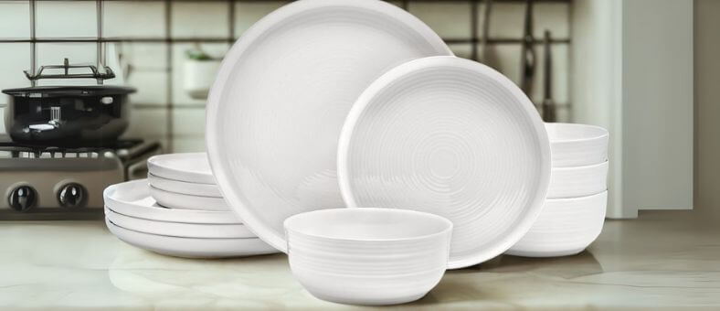 Mikasa Callie 12-piece bone china dinnerware set with subtle textured patterns, arranged on a countertop, showcasing dishwasher-friendly elegance.