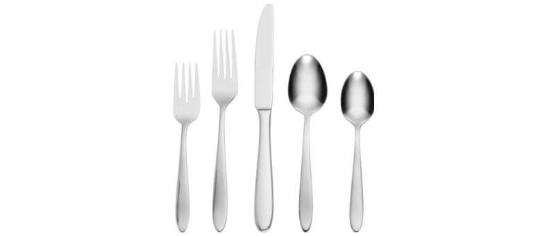 Oneida Mooncrest 45-piece flatware set with smooth, rounded handles and highly reflective stainless steel finish, arranged on a white surface.