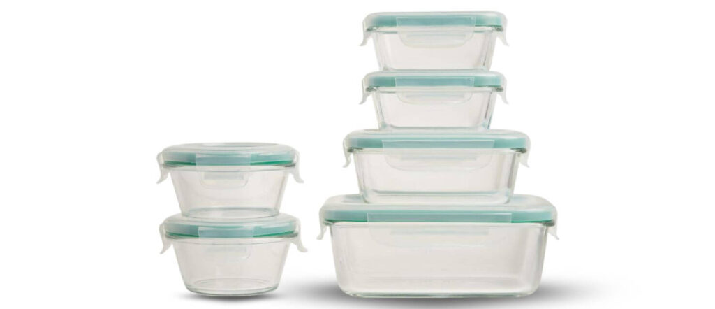 Set of OXO Good Grips Smart Seal dishwasher-safe glass food containers in various shapes and sizes with light blue lids.