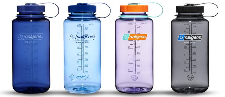 Four Nalgene Sustain Tritan BPA-free plastic water bottles with wide mouths and measurement markings, made from 50% recycled plastic and available in multiple translucent colors.
