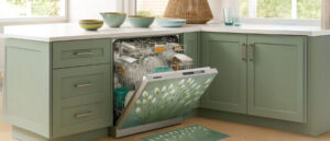 Modern kitchen featuring an open dishwasher with floral-designed Dishwasher Magnet Covers matching the mint green cabinetry and decor.