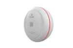 01-Kidde WiFi Water Leak Detector Small Circular Kidde water leak detector placed on a wet floor, showing active water detection.