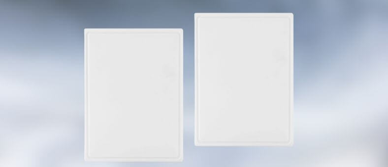 A pair of simple white plastic boards with wide cutting surfaces and subtle textured edges, great for large meal prep.