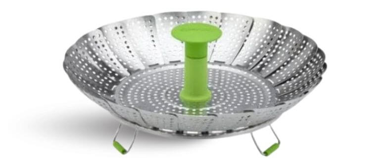 Image shows a collapsible metal steamer basket with a green silicone handle and legs for stovetop use.