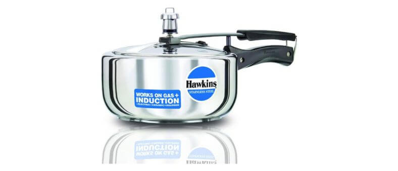 Hawkins pressure cooker with curved base and induction-compatible label on the side.
