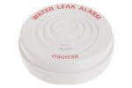 06- Flo by Moen Smart Water Leak Detector Small Round Resideo water leak alarm sitting in a large water puddle on a smooth surface.