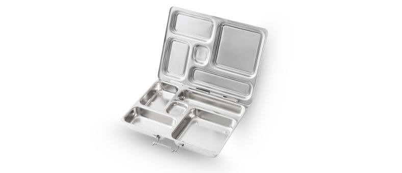 A large stainless steel lunchbox opened to reveal multiple uniquely shaped compartments with a hinge-style design.