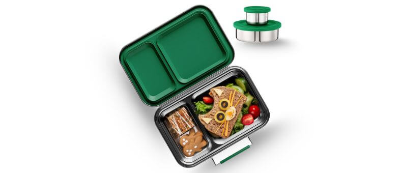 A stainless steel lunchbox with two main compartments filled with food and a green dual-lid cover, accompanied by matching sauce containers.