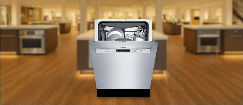 BOSCH SHEM63W55N Dishwasher Review image showing the built-in (under-counter) dishwasher is placed in a showroom, emphasizing its streamlined front panel and modern aesthetic.