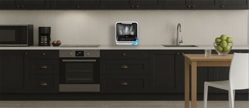 A size comparison graphic illustrating the Midea MDC17P0ABB dishwasher's dimensions in relation to a kitchen counter and standard human heights. The diagram provides a visual reference for users to gauge its compact form factor and placement in a typical kitchen setup.