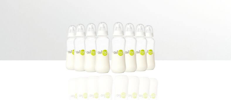 Avima Anti-Colic Baby Bottle Set – Eight filled clear baby bottles with white caps and yellow-green logos, arranged in a row on a white background.