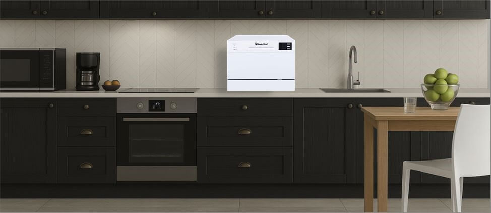 A visual size comparison chart displaying theMagic Chef MCSCD6W5 dishwasher alongside a standard kitchen counter and average human heights. The graphic helps users understand its compact dimensions and how it fits within a regular kitchen environment.