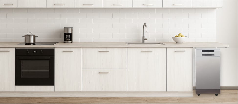 A sleek, modern kitchen featuring minimalistic cabinetry and polished surfaces. Positioned neatly in the corner, the freestanding SPT SD-9263WAdishwasher blends convenience with flexibility, showing how well it fits into a functional yet dynamic kitchen space.